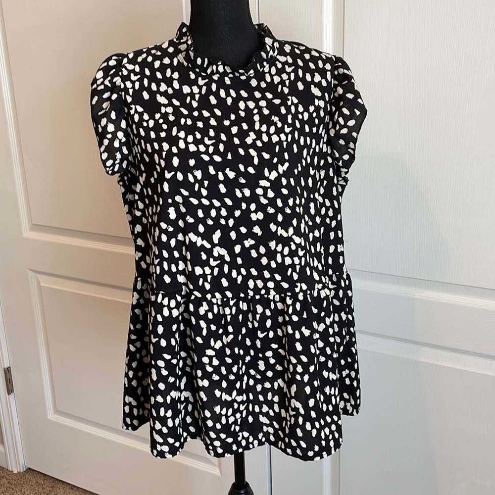 Black polka dotted sleeveless blouse
